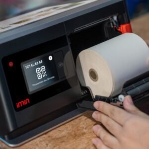Hands setting up a thermal roll in a point-of-sale touchscreen device.